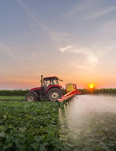 Image with tractor that spraying pesticides on farm